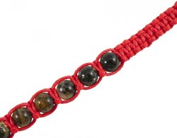 Amulet beads with a red thread and greenish amber balls