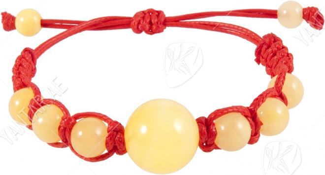 Amulet bracelet with red thread and light amber balls