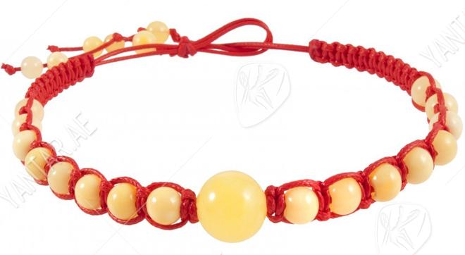 Amulet beads with red thread and light amber balls