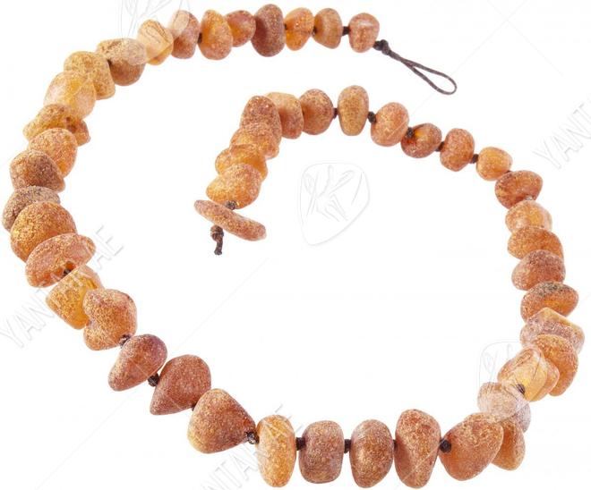 Beads-stones made of polished amber through a knot (medicinal)