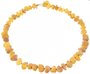 Stone beads made of light polished amber through a knot (medicinal)